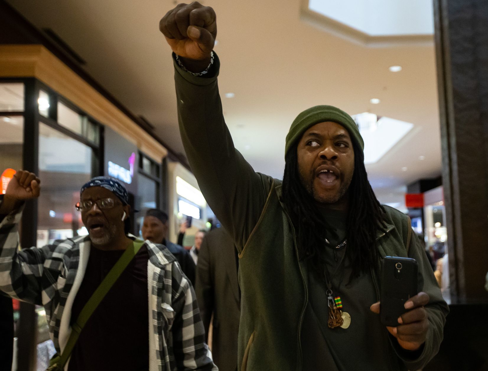 Protesters march in the St. Louis Galleria on Black Friday